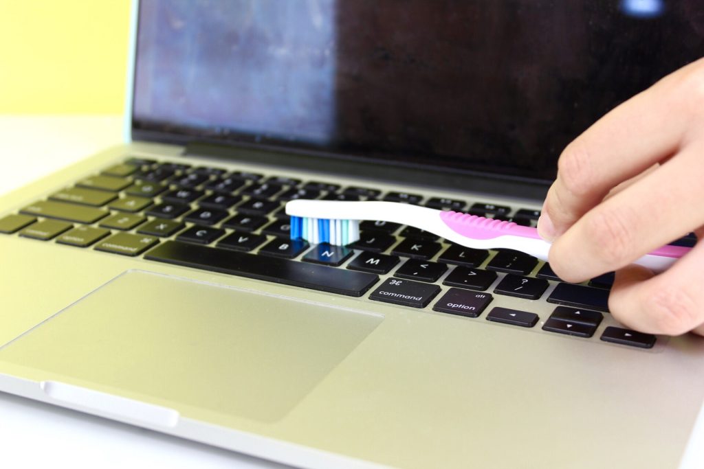 Use a Toothbrush To Clean In Between Keyboard Keys