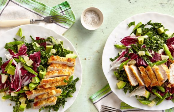 breaded pork cutlet with avocado and shredded kale salad recipe for spring