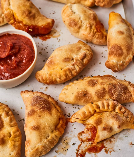 Air fryer mini calzones served with additional pizza sauce