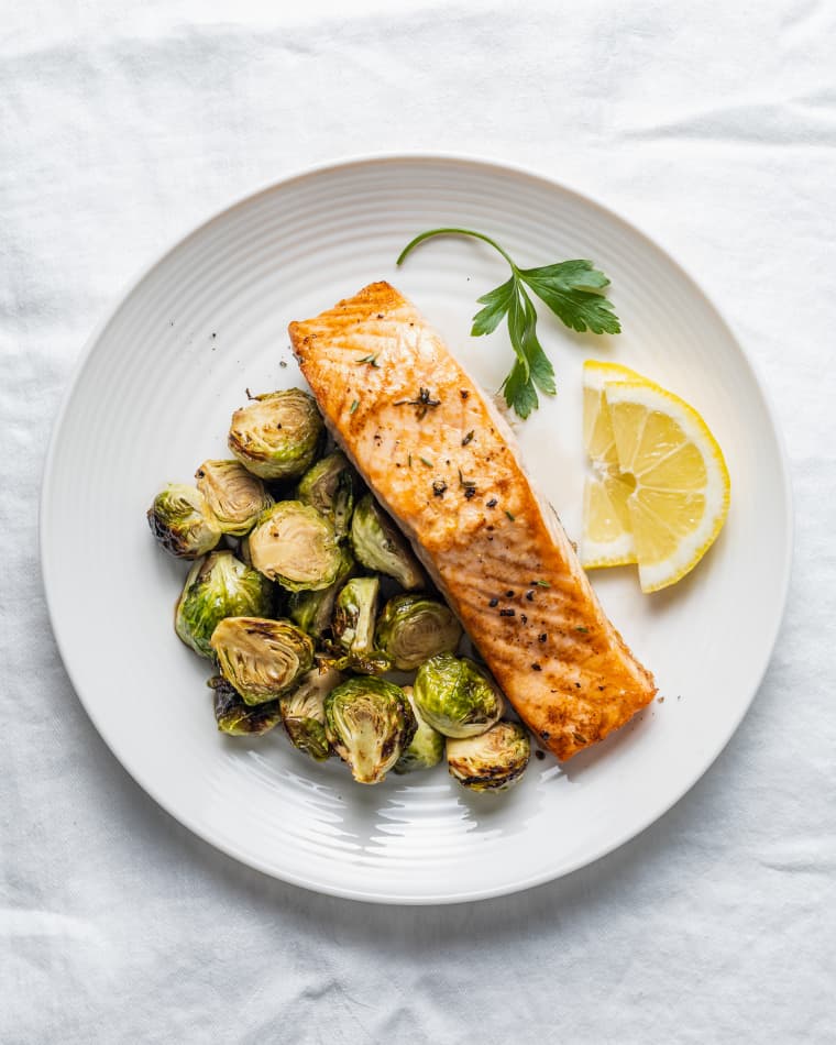 Air fryer salmon with brussels sprouts and slice lemons