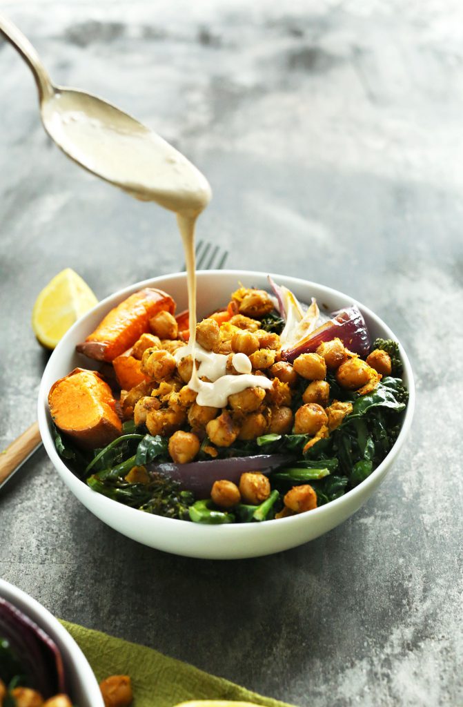 Buddha Bowl with roasted sweet potatoes, onion, kale, crispy chickpeas, and tahini-maple sauce.  A healthy, satisfying plant-based meal.