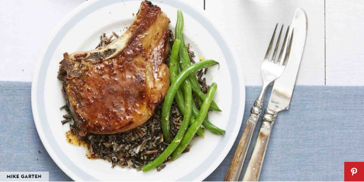 Pork chops with mustard sauce served with wild rice and green beans.