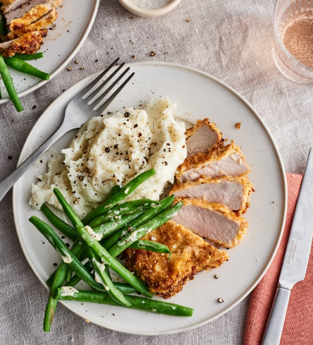 Air fryer pork chops served with mashed potato and green beans 