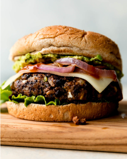Black bean burger with mashed avocado, caramelized onion, pepper jack cheese and spicy mustard 