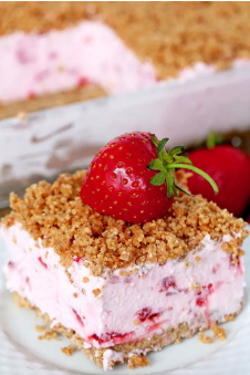 Refreshing creamy frozen strawberry dessert with graham cracker layer and crumbs