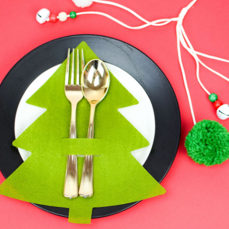Color green felt Christmas tree utensils holder with a spoon and fork on it