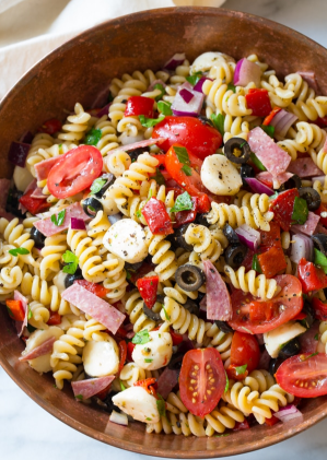 Italian pasta salad with salami, black olives, tomatoes, and cheese.