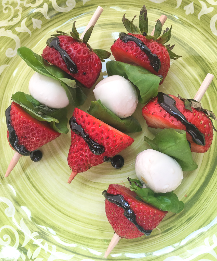 Strawberry caprese skewers with balsamic glaze. 