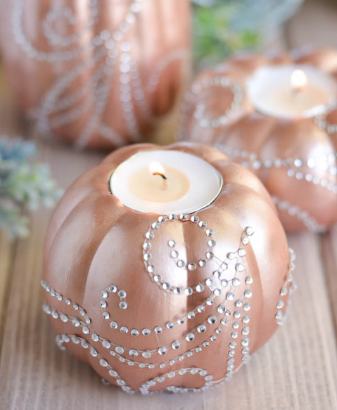 Rose gold pumpkins with rhinestones on it