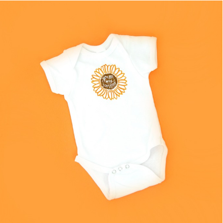 Babies fall onesie with a cute flower design at the middle