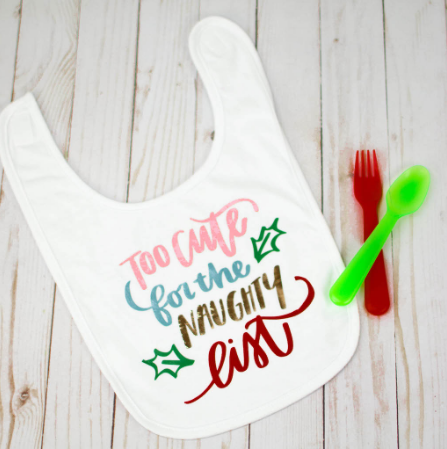 Iron on baby bib with a text saying too cute for the naughty list