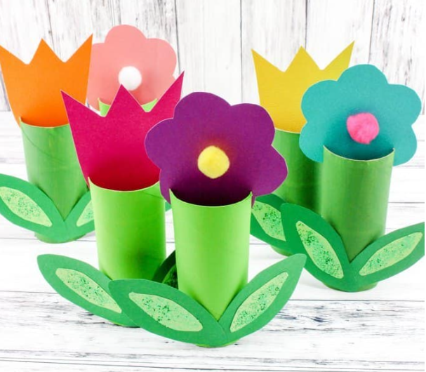 Different colors Paper Roll Spring flowers with a two grass shape on the bottom. 