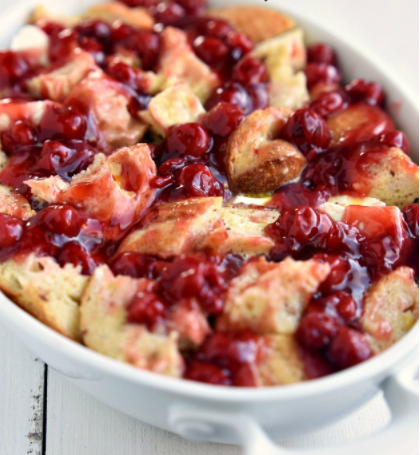 Baked cherry cheesecake french toast with a drizzle of maple syrup