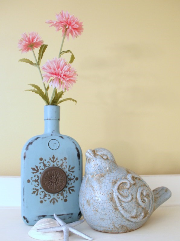 Chalk painted bottles with oil rubbed bronze spray paint on them.