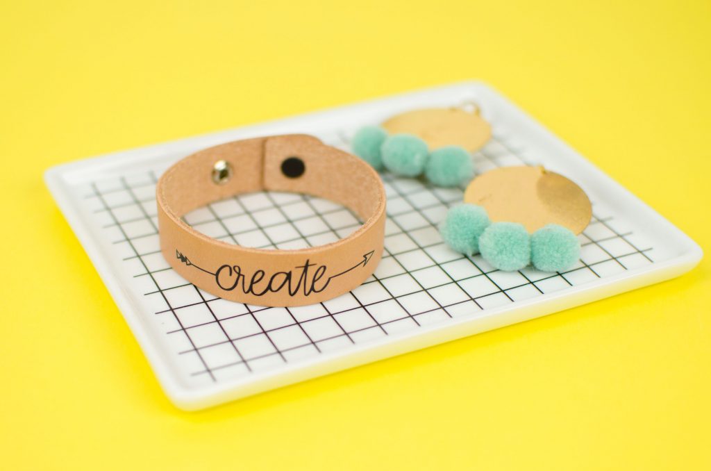 Cute leather bracelets with an arrow text on it saying create