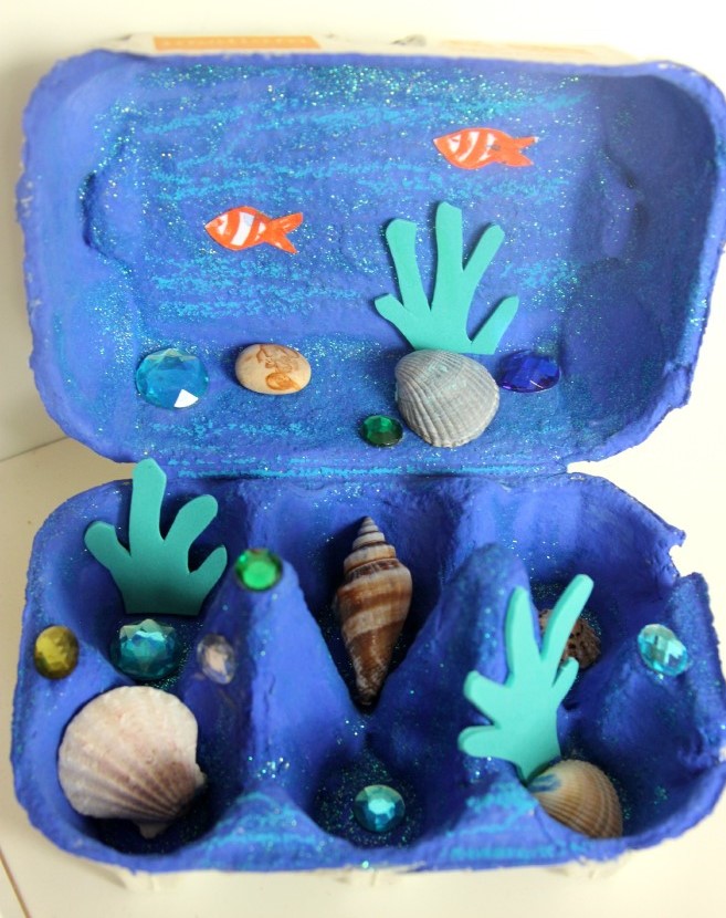 Egg carton ocean decorated with seashells and fish
