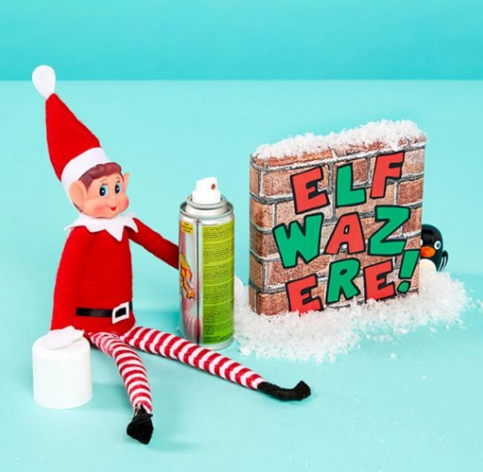 elf on the shelf is being naughty and writing on the wall