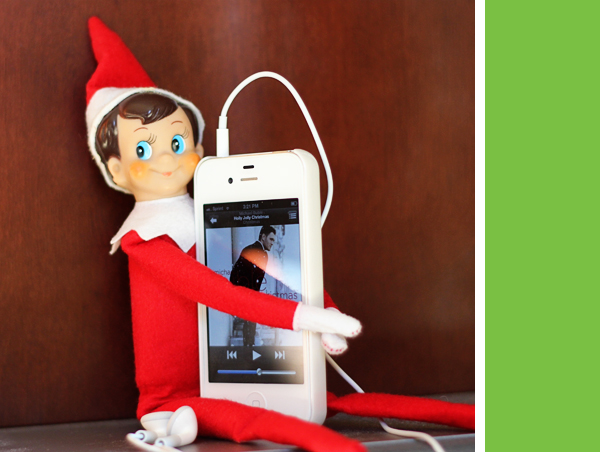 elf on the shelf listening to christmas music on spotify/apple music from his iphone
