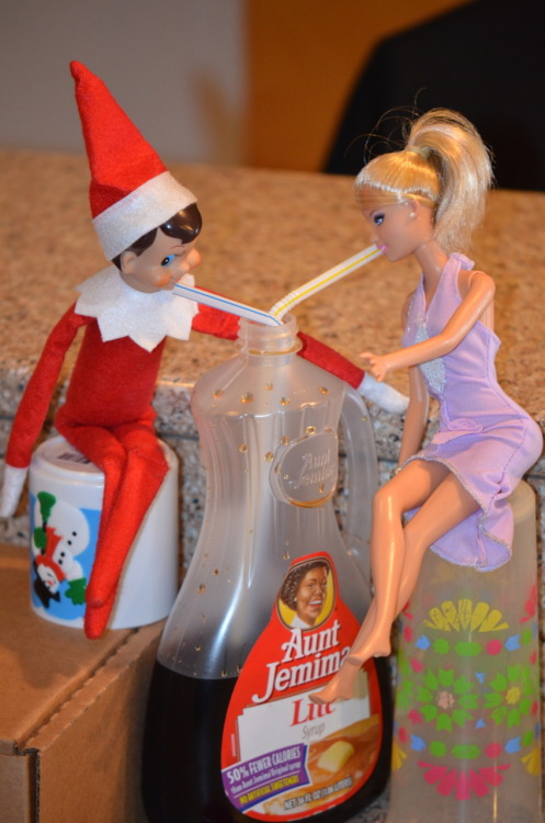 elf on the shelf on a date with barbie and they are sipping a syrup 