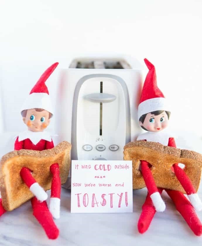 elves on the shelf are cold so they are getting warm and toasty
