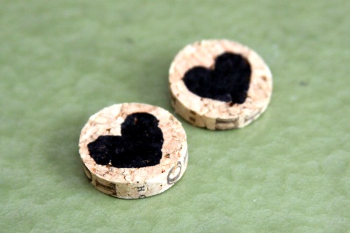 Wine cork earrings with a color black heart design on them