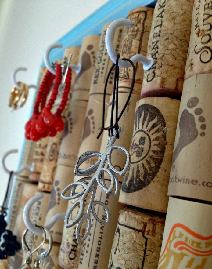 Wine cork jewelry organizer with some bracelet and earrings hang on it