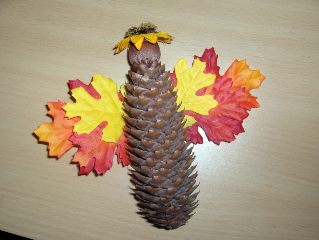 pine cone angel with wings made of autumn leaves 