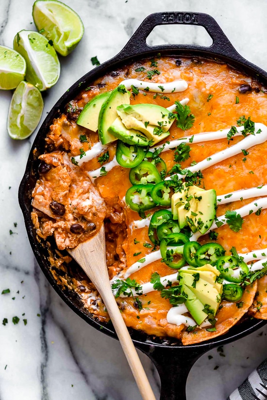 Cheesy Rotisserie Chicken Enchilada Skillet topped with sour cream, jalapeños, and cilantro