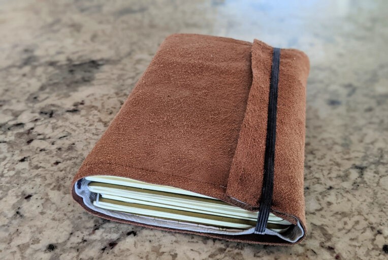 travelers journal cover with pockets and bands for three to five notebooks