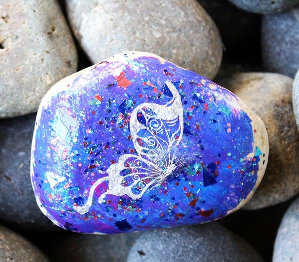 Sparkly, galaxy style butterfly painted rocks