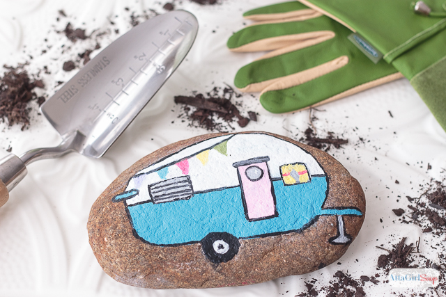 painted rocks decorated with a bright and colorful vintage camper