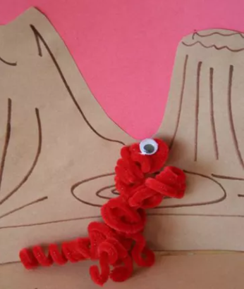 A red dinosaur toy using a pipe cleaner