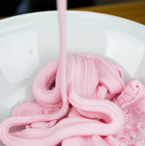 Light pink cornstarch slime that is wonderfully stretchy