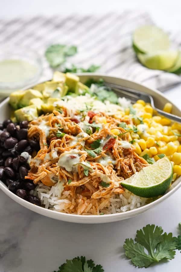 Slow Cooker Chicken Burrito Bowl drizzled with a delicious cilantro lime dressing