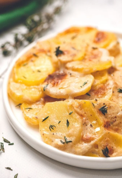 Homemade Scalloped Potatoes dish smothered in a rich cream sauce and deliciously baked