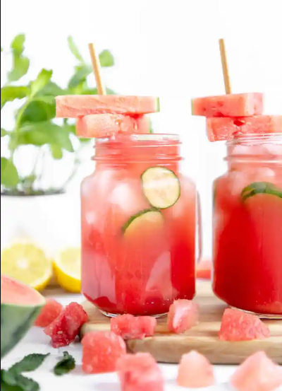 refreshing watermelon cucumber lemonade drink with a mint and cubed watermelon garnish