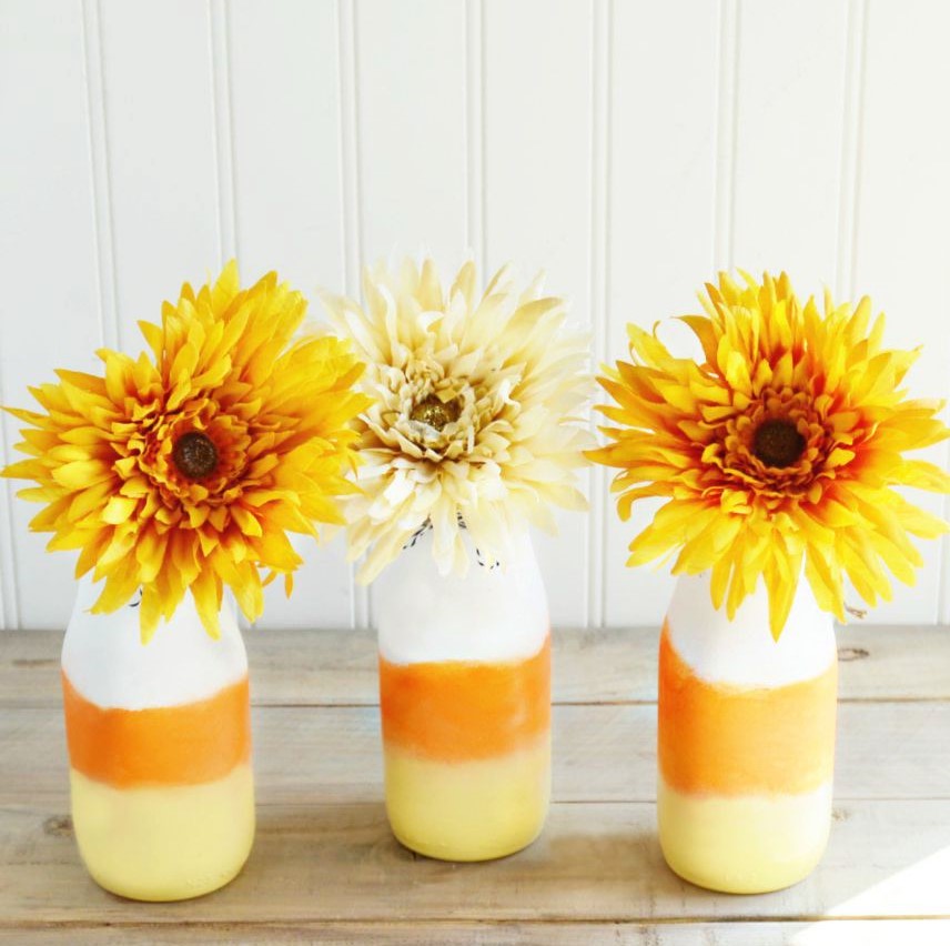 DIY Candy Corn Vases from empty glass bottles with faux fall flowers