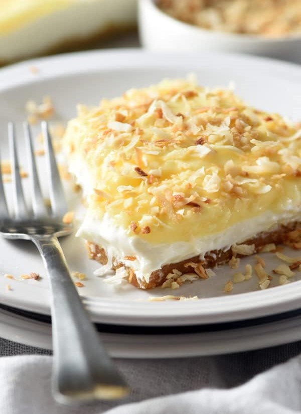 No-Bake Coconut Cream Lush Dessert with toasted coconut flakes over the top