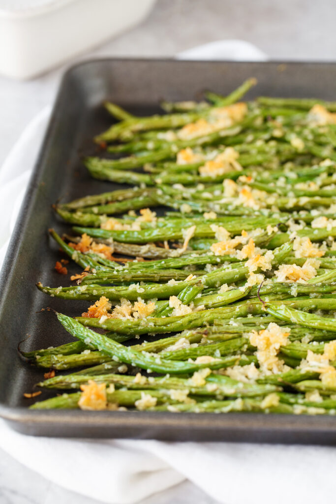delicious fresh green beans are roasted with a crunchy mixture of parmesan cheese and panko bread crumbs a perfect fall side dish for any meal