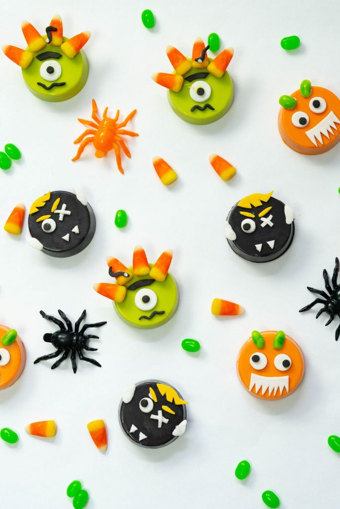 Green Cyclops, with Medusa hair; Black Dracula, crossed with Frankenstein and Orange Googly-Eyed Bug with scary teeth Chocolate Covered Monster cookies 